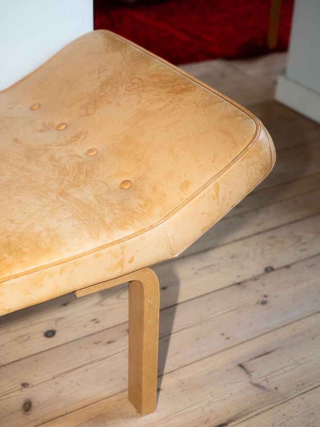 A patinated leather bench