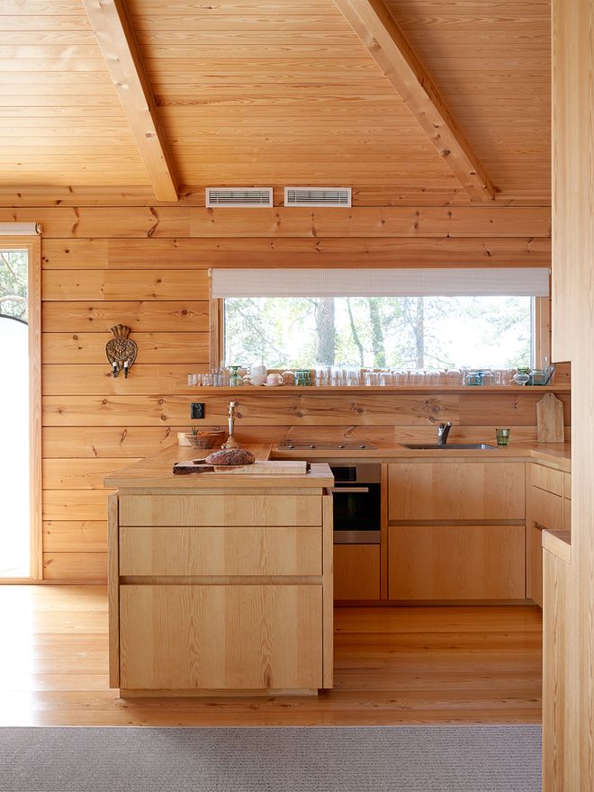 The cabin kitchen, where the custom-built cabinets salvaged from the old house have been supplemented and reorganized into a compact whole.