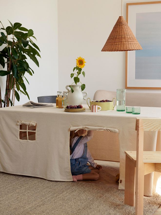 Child playing in the Settle tablecloth house