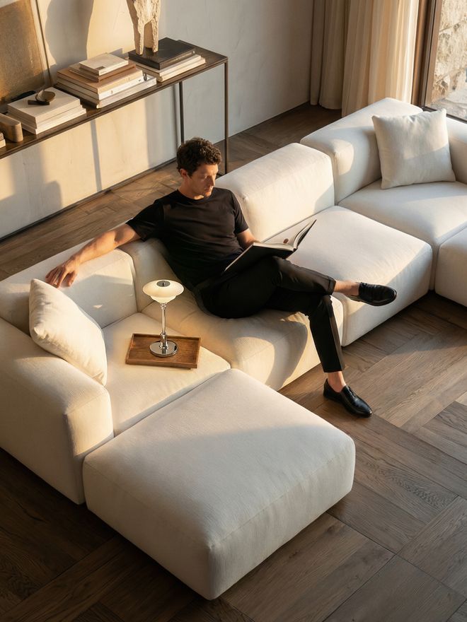 Louis Poulsen PH 1/1 Portable Lamp with white opal glass shades and chrome base on a wooden tray, on a coffee table in a contemporary living room