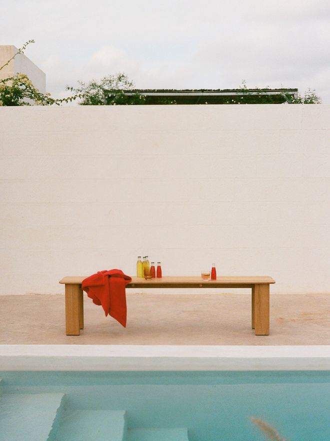 Front view of Assemble teak bench by the pool