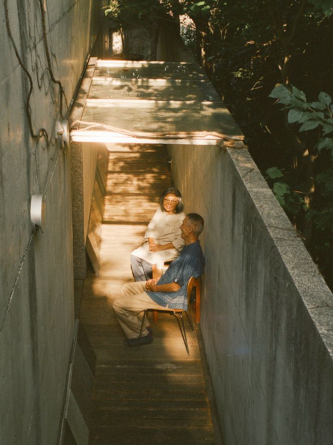 The couple sitting outdoors under a sun shade