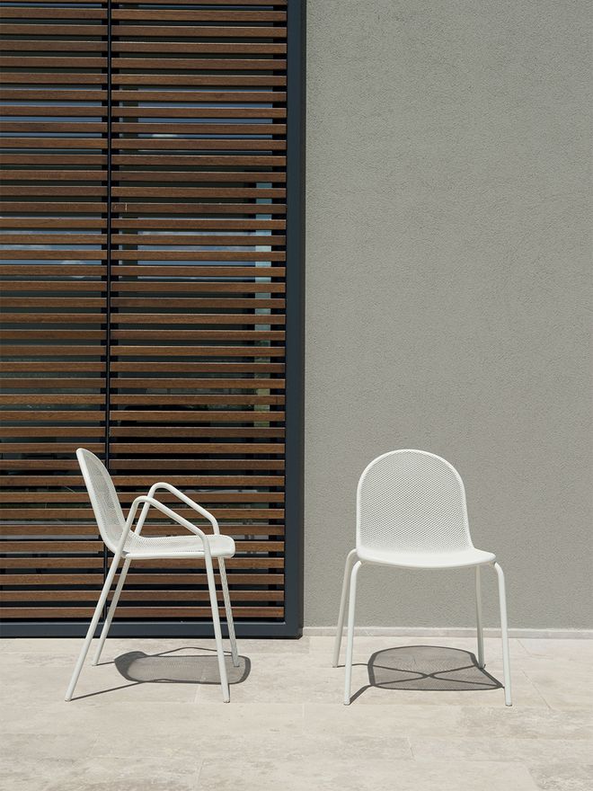 Emu's Nova armchair and chair outside.