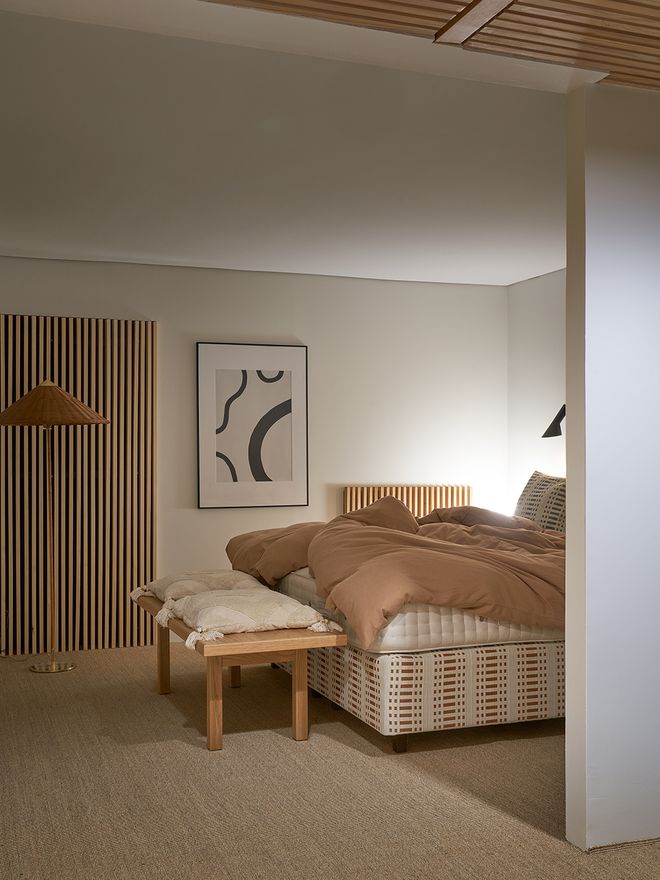A view of the bedroom with a sisal carpet.