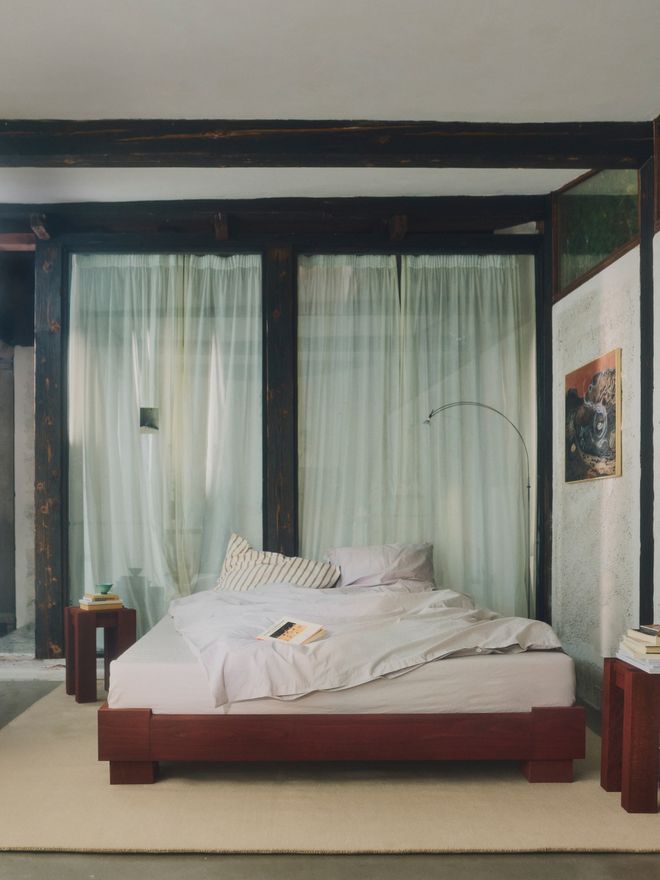 RYE's dark bed frame in a serene interior