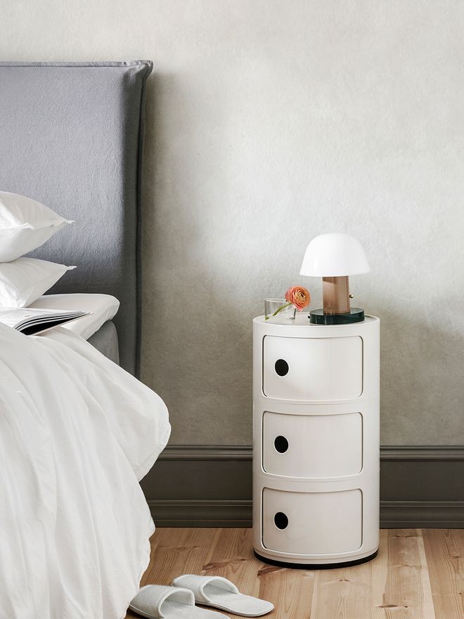 Kartell's Componibili storage unit in a bedroom.