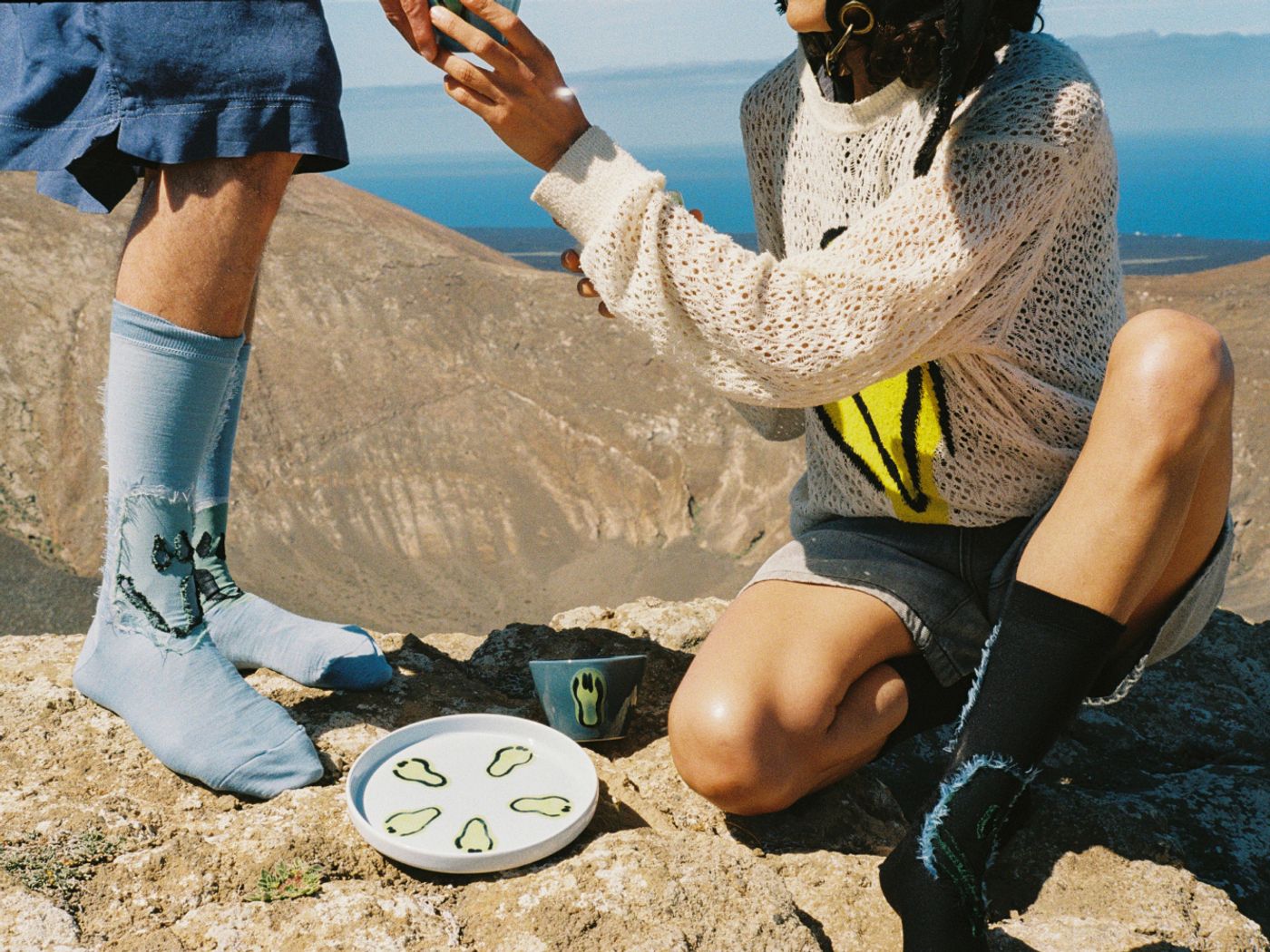 Close-up of two people with colorful Frizbee Ceramics tableware