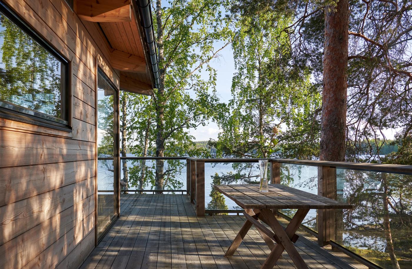 A view over Lake Saimaa from the cabin's upper terrace on a summer day.