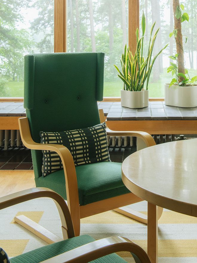 Interior view of Kantola in Sunila, featuring Alvar Aalto's green 401 armchairs