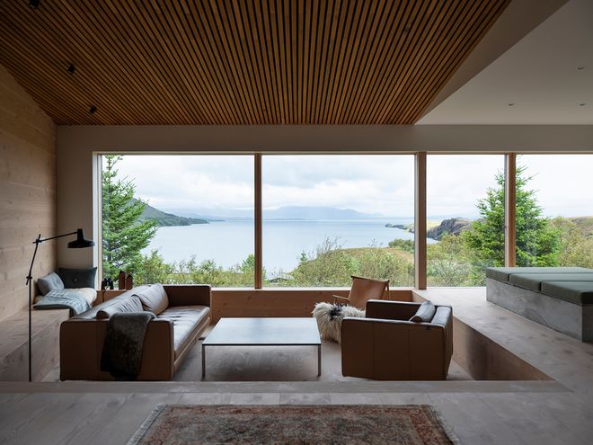 An image of the Holiday home by Þingvallavatn by KRADS architects: a leisure home located in Iceland in the middle of a picturesque scenery. This image features the buildings interior: the lounge area decor.