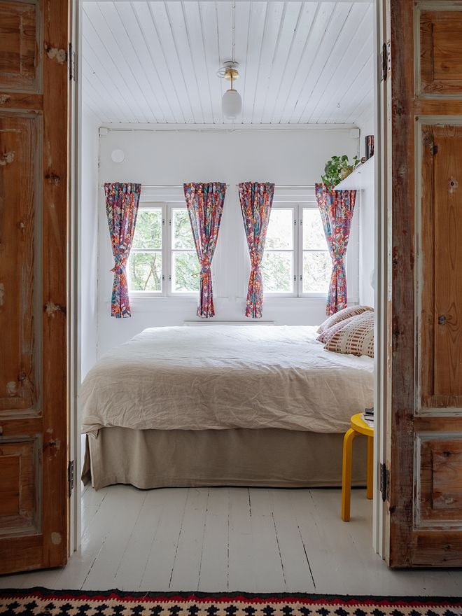 The parents' bedroom with two windows and old wooden doors