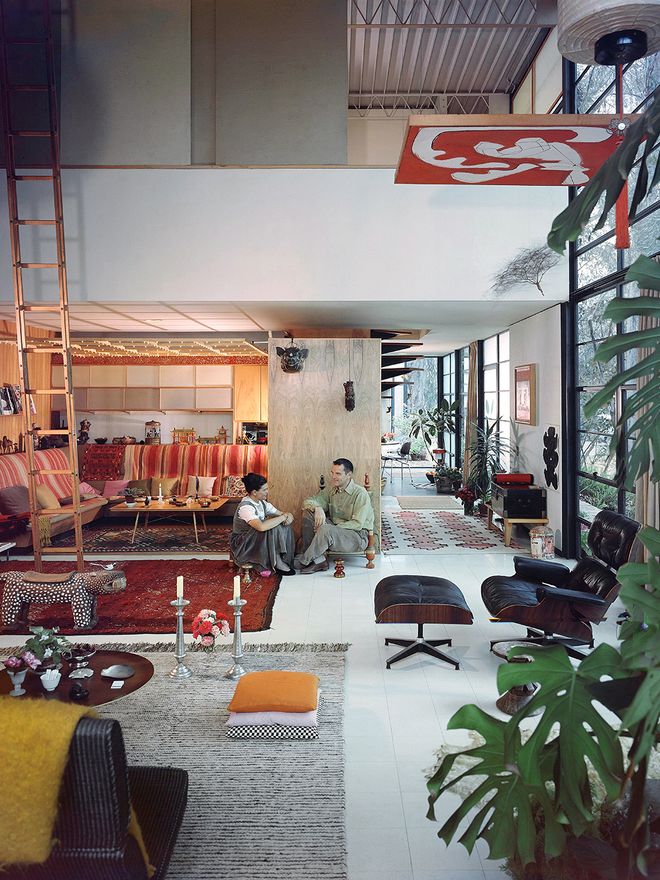 Charles and Ray Eames sitting in their living room.