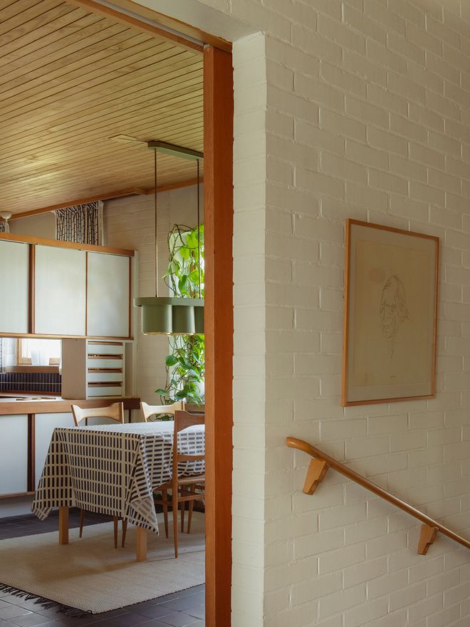 View from the entrance hall of Villa Skeppet toward the dining area and semi-open kitchen, separated by a wide wooden sliding door