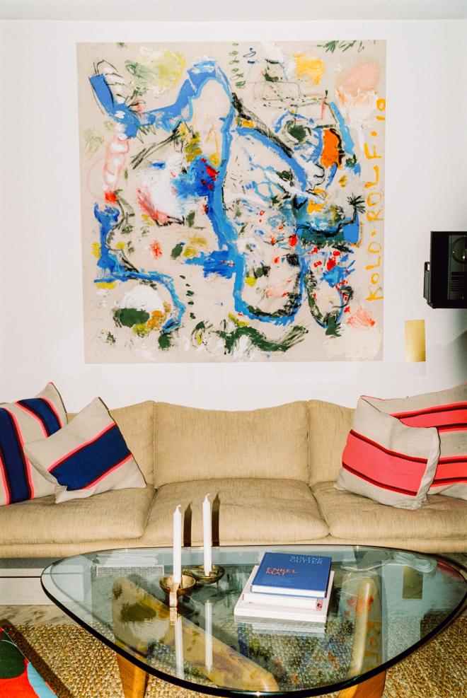 Detail view of a livingroom corner in Fredrik Bull’s Oslo apartment, showing layered artworks, crafted objects, and warm materials that express his love of art and craftsmanship
