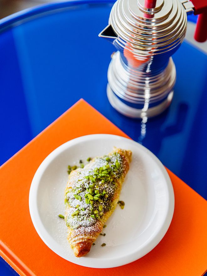 Alessi Pulcina espresso coffee maker and a pistachio croissant