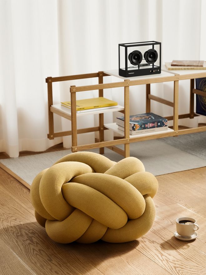 An image featuring Design House Stockholm's Knot cushion as part of the living room decor.