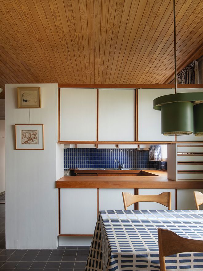 The semi-open kitchen at Villa Skeppet, with a wooden cabinet divider between the kitchen and dining area — a design solution favored by Aino and Alvar Aalto since the 1930s