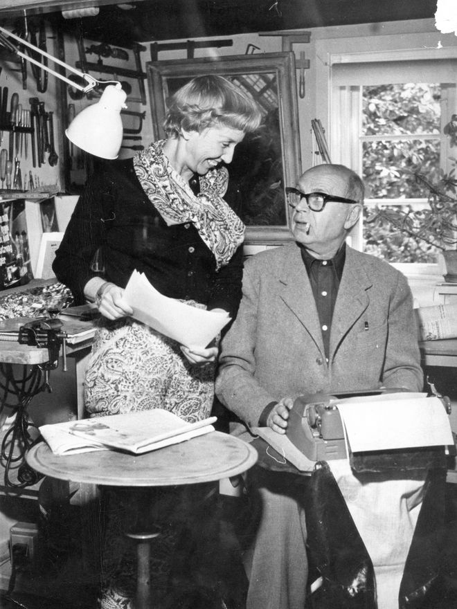 Poul Henningsen and his wife Inger Henningsen reviewing design work in their studio, mid-20th century black-and-white photograph