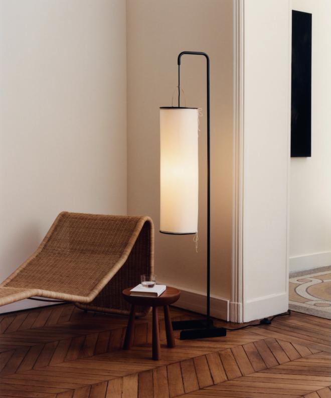 GUB's Silk Lantern floor lamp in a minimalist interior, placed next to a rattan chair