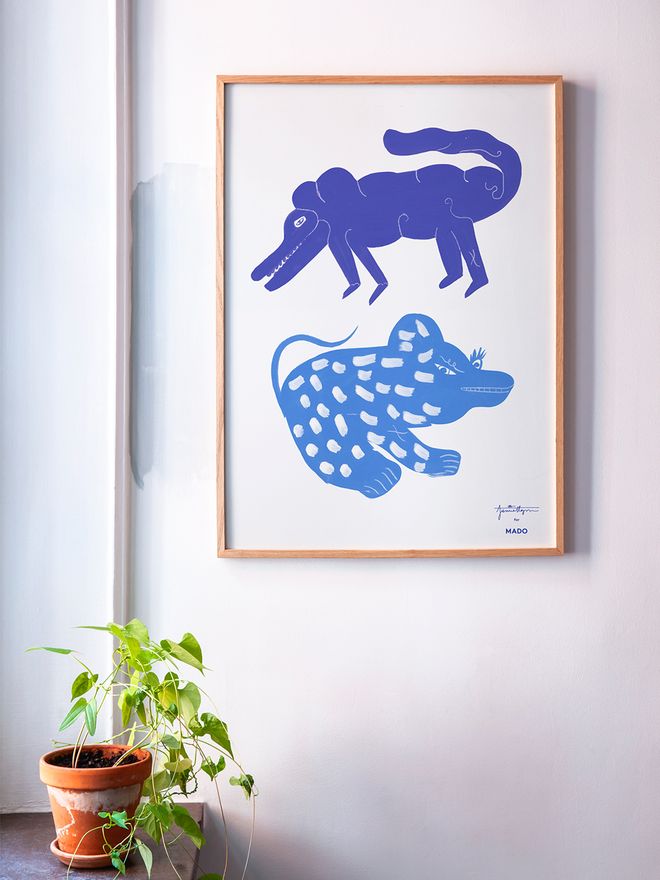 MADO's Two Creatures poster hung up on the wall.