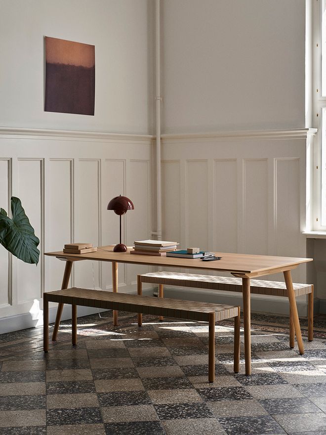 An image of &Tradition's Betty TK5 benches and Flowerpot VP3 table lamp as part of the dining room decor.