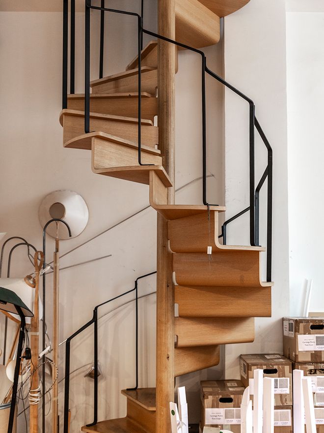 Wooden spiral staircase connecting Inga Sempé's apartment and studio in Paris