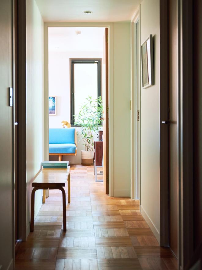 A corridor leading to a living room space