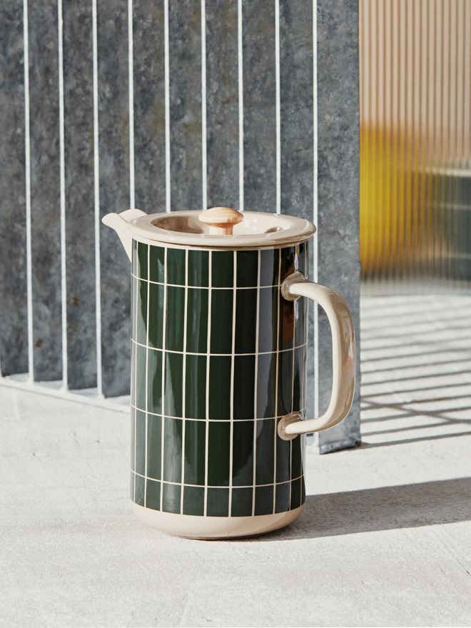 An image of Marimekko's Tiiliskivi press coffee maker against a metal sheet background.