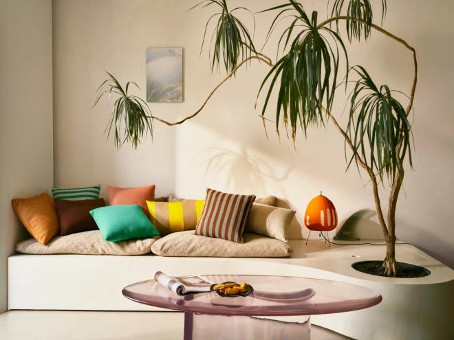 Colorful cushions and a glass table in a living room