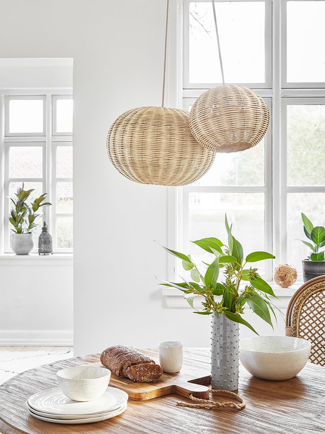 Sika-Design's Tangelo pendants in sizes XS and S hung over a dining table.