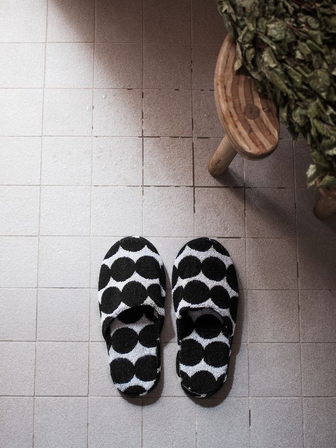 Marimekko's Räsymatto slippers placed on the bathroom floor.