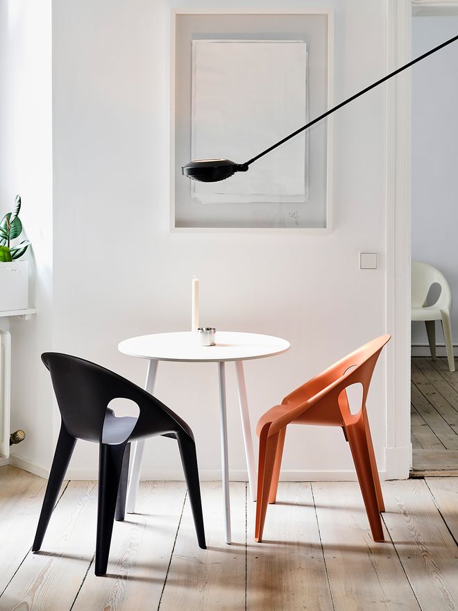 Black and red Bell chair around the First table