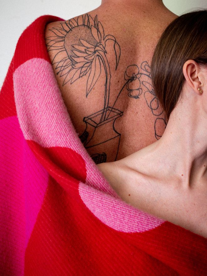 Two people wearing the Teenagers from Mars blanket in red shades