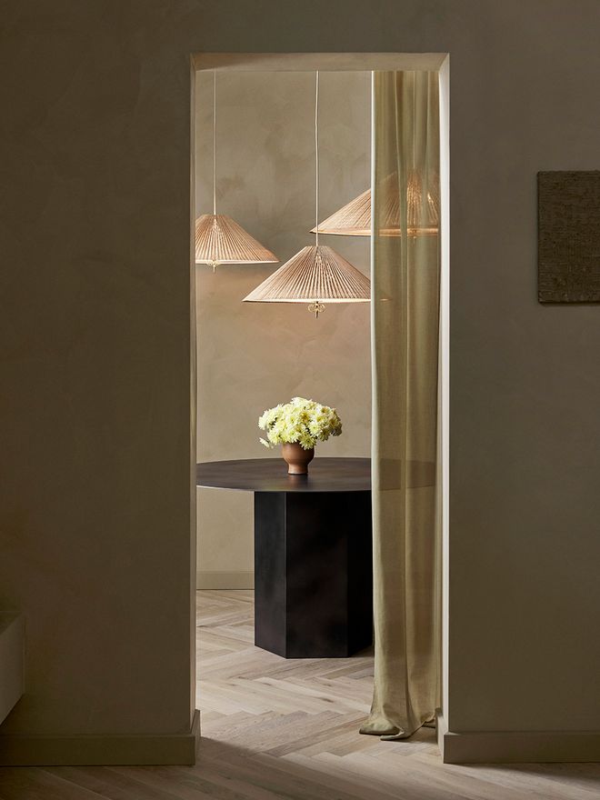 An image featuring GUBI's Paavo Tynell's lamps as part of the living room interior.