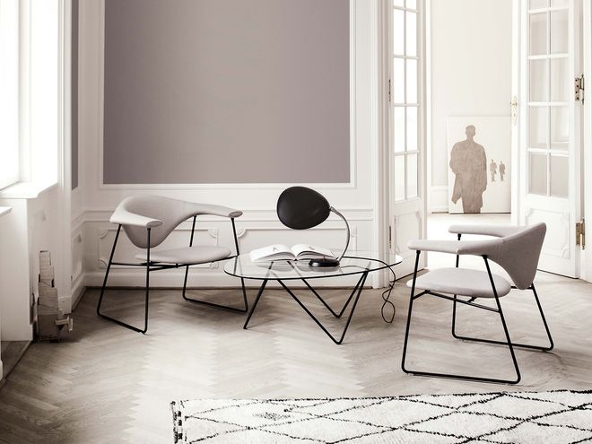 Gubi's Masculo-chairs, Pedrera coffee table and Cobra table lamp in a living room setting.