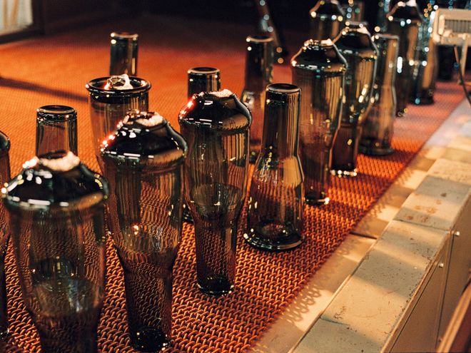 Solare vases being made at the Iittala Glass Factory: a row of vases waiting for final touches