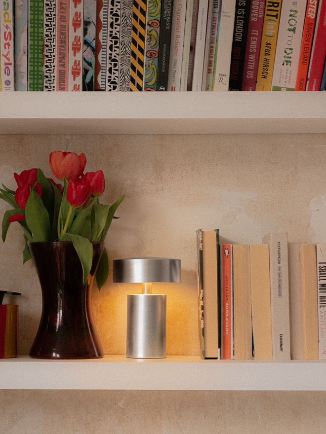 Column table lamp on a bookshelf