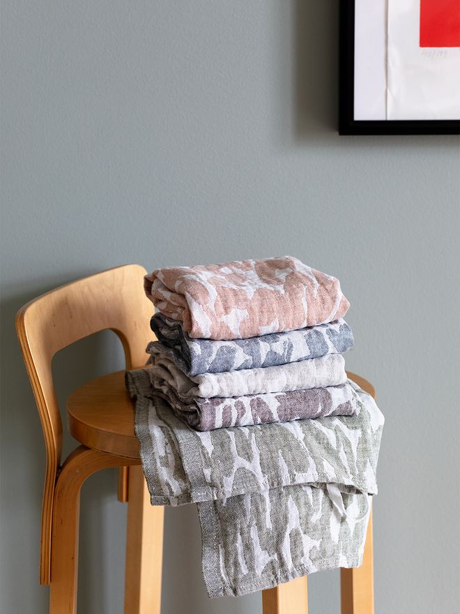 An image of Jäkälä towels stacked up on a chair.