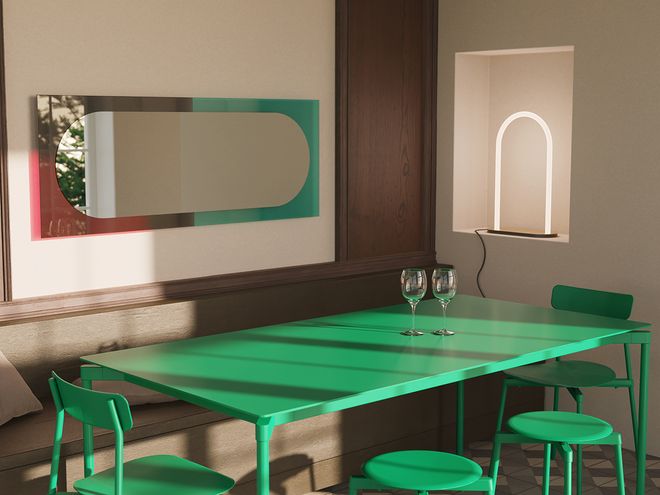 The large Wander mirror in shades of emerald and cherry hung on the wall horizontally