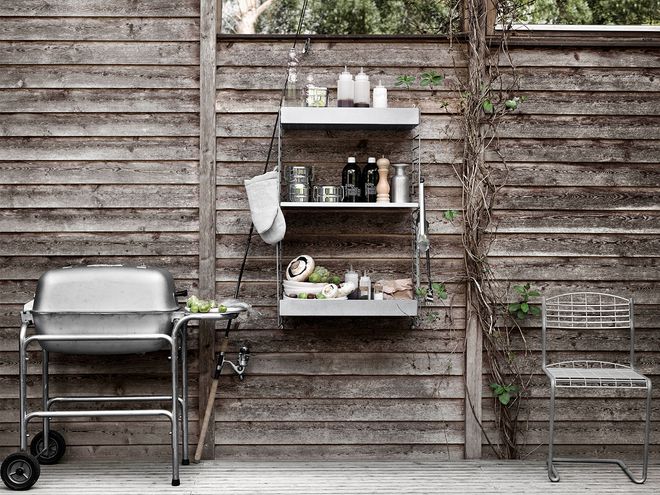 String Furniture's String Outdoor shelving on a patio.