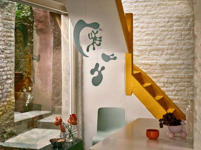 Vitra mobile, small staircase and a large window with greenery