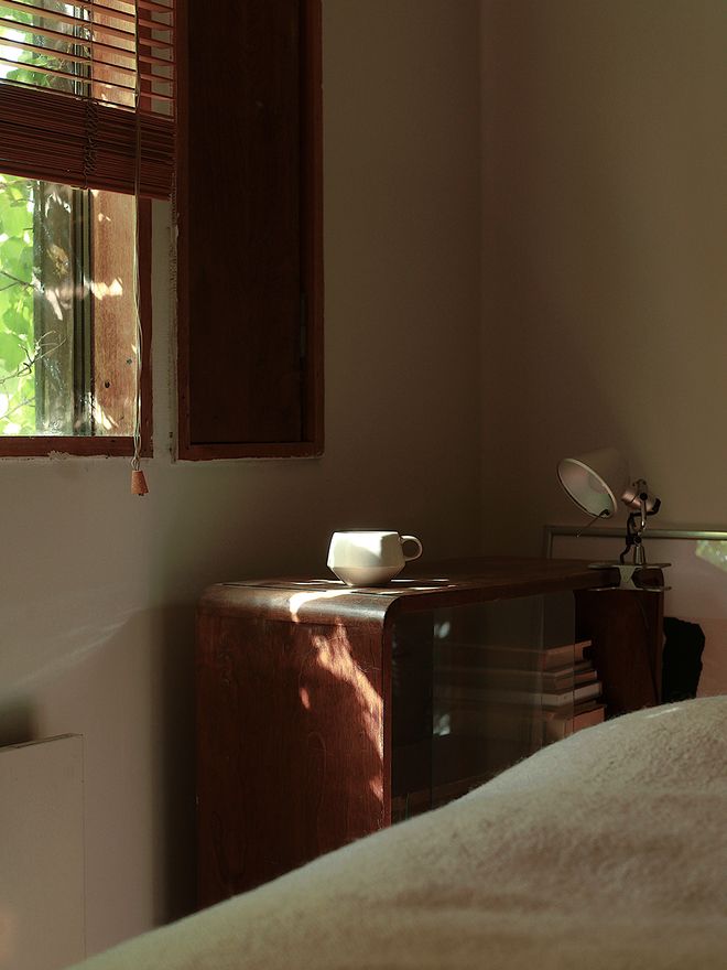 A white coffee cup on top of a wooden drawer