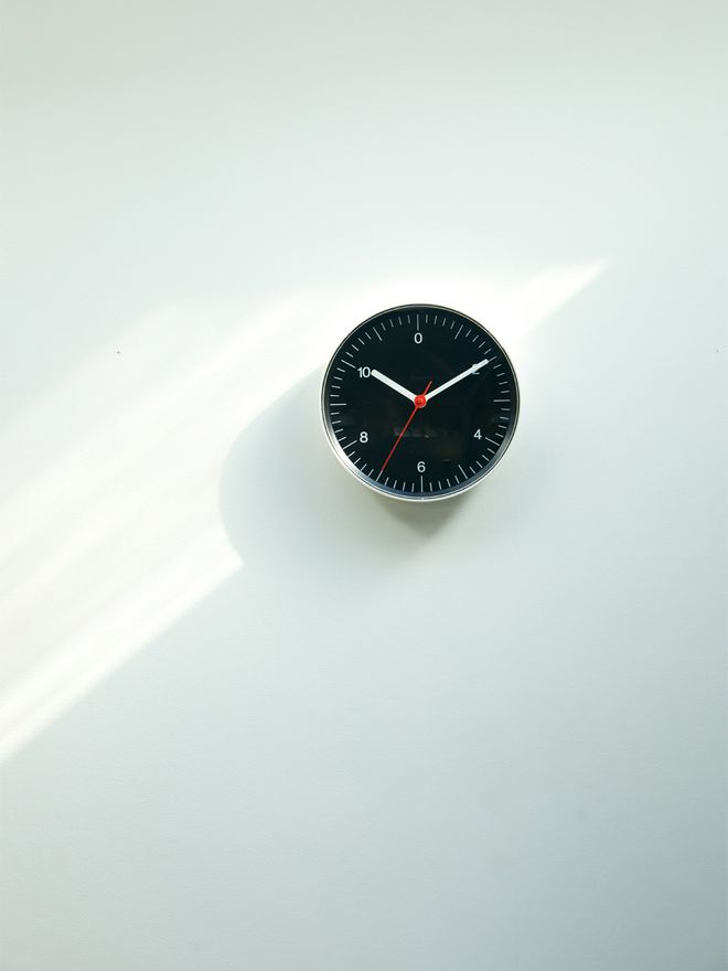 The black Wall Clock on a wall