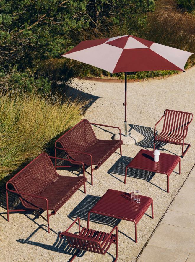 Various Palissade furniture in a summer park under a parasol