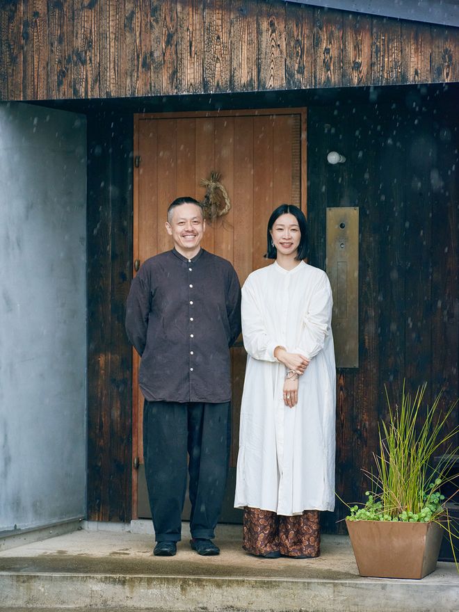 A couple standing in front of an entrance
