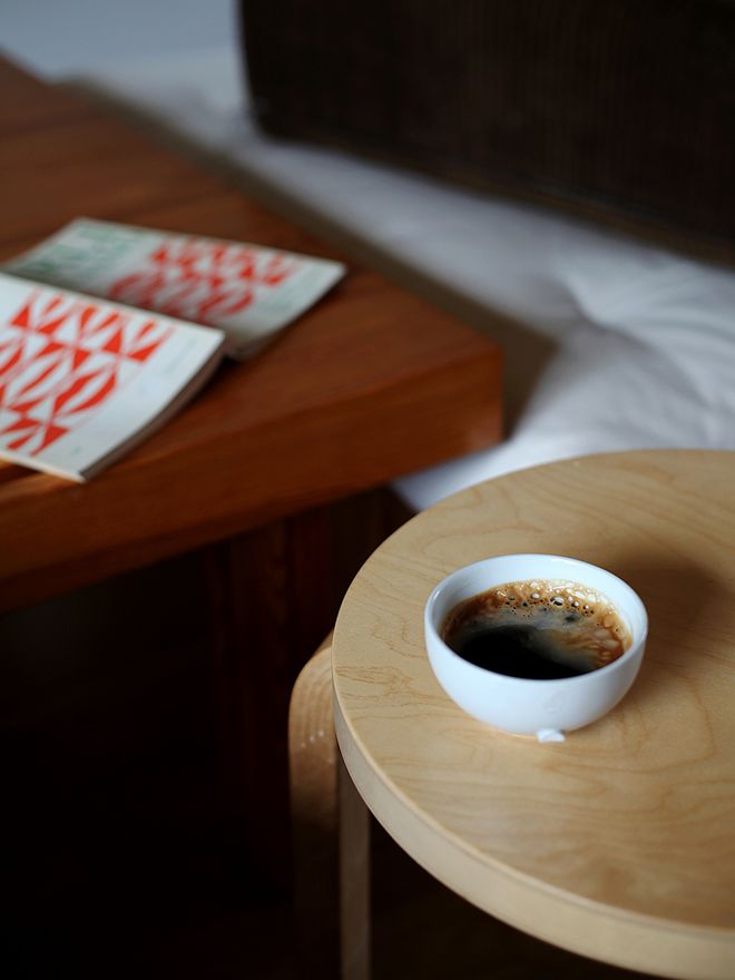 A coffee cup on an Artek stool.