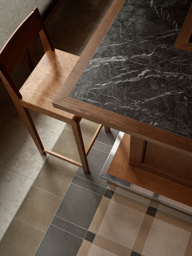A close-up of a stone table and tile floors