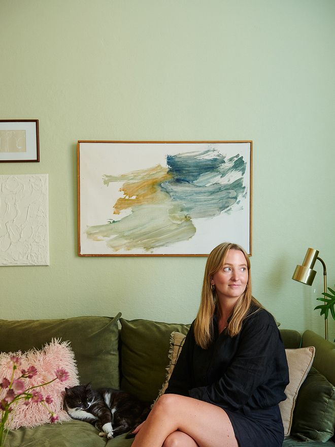 A portrait of Katarina Fredrikson sitting on a sofa