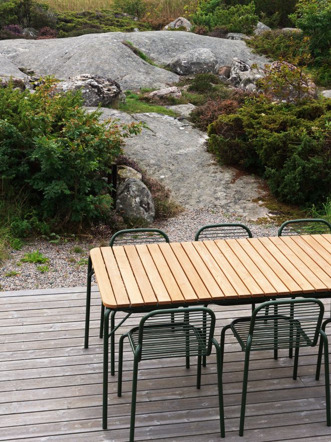 Wooden patio table and metal chairs on the terrace
