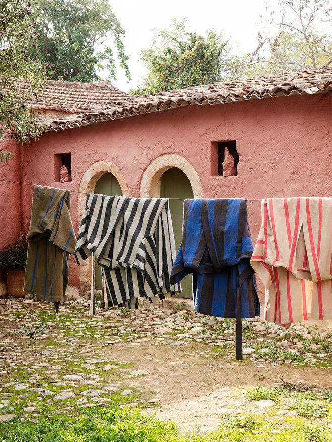An image of ferm LIVING's Field robes hung on a clothes line.